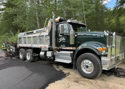 Sutco Transportation Specialists Tandem Dump Truck Delivering Asphalt